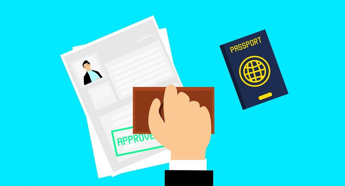 A passport and a visa stamp. Person approving a visa on a passport