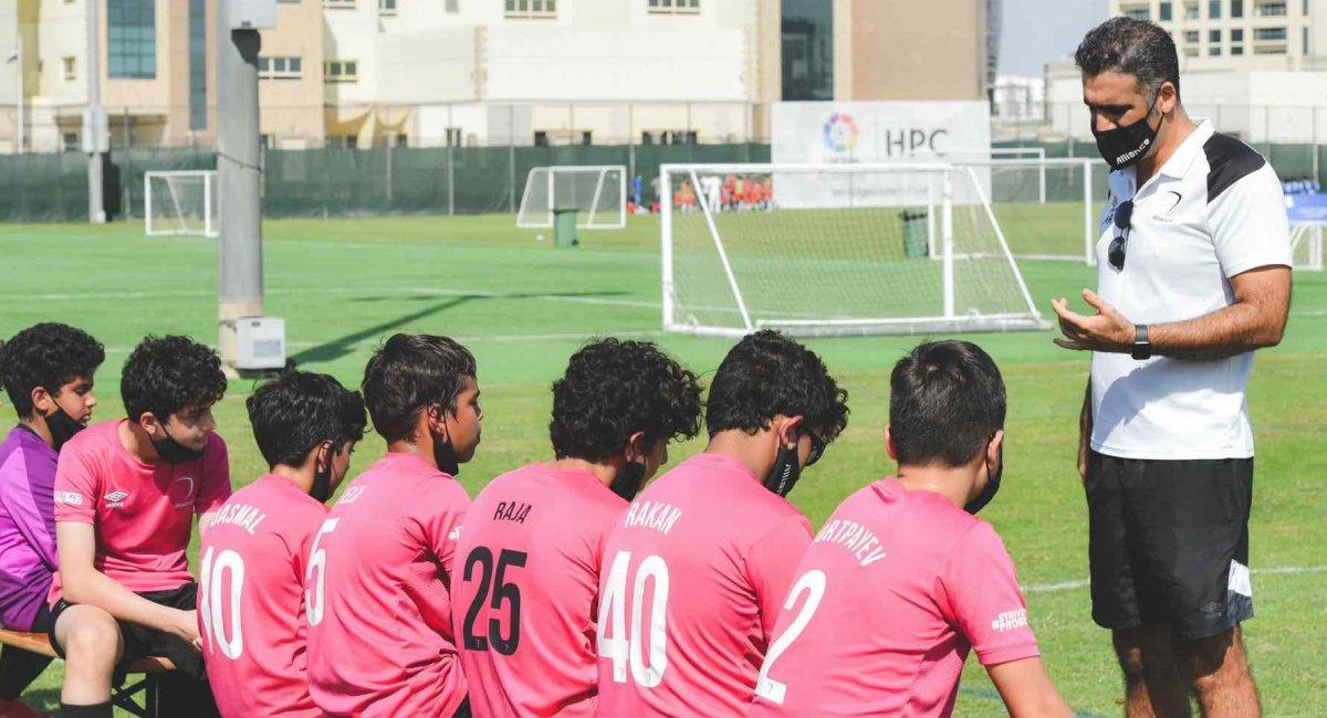 A coach speaking to a soccer team