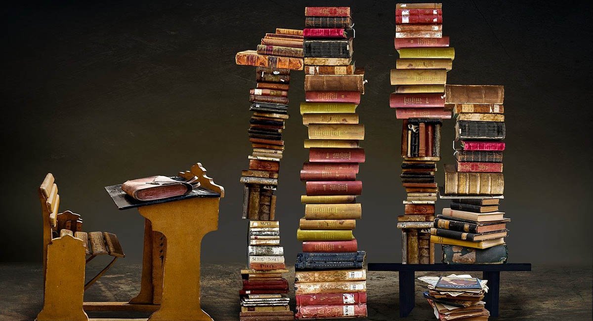 old desk with stacks of old books