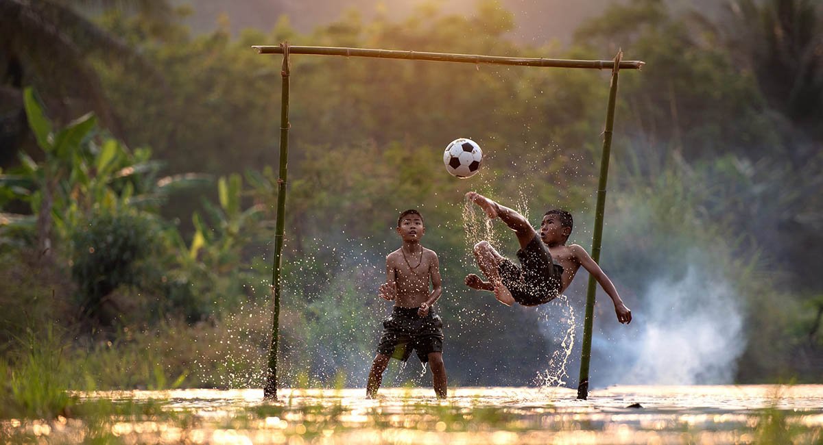 Prepare to do your best To Vietnamese boys playing soccer splashing water