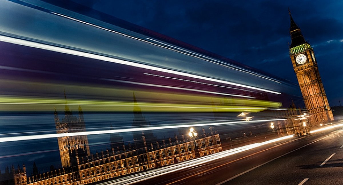 Big Ben at night with long-exposure headlights
