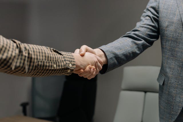 Two people shaking hands in an office