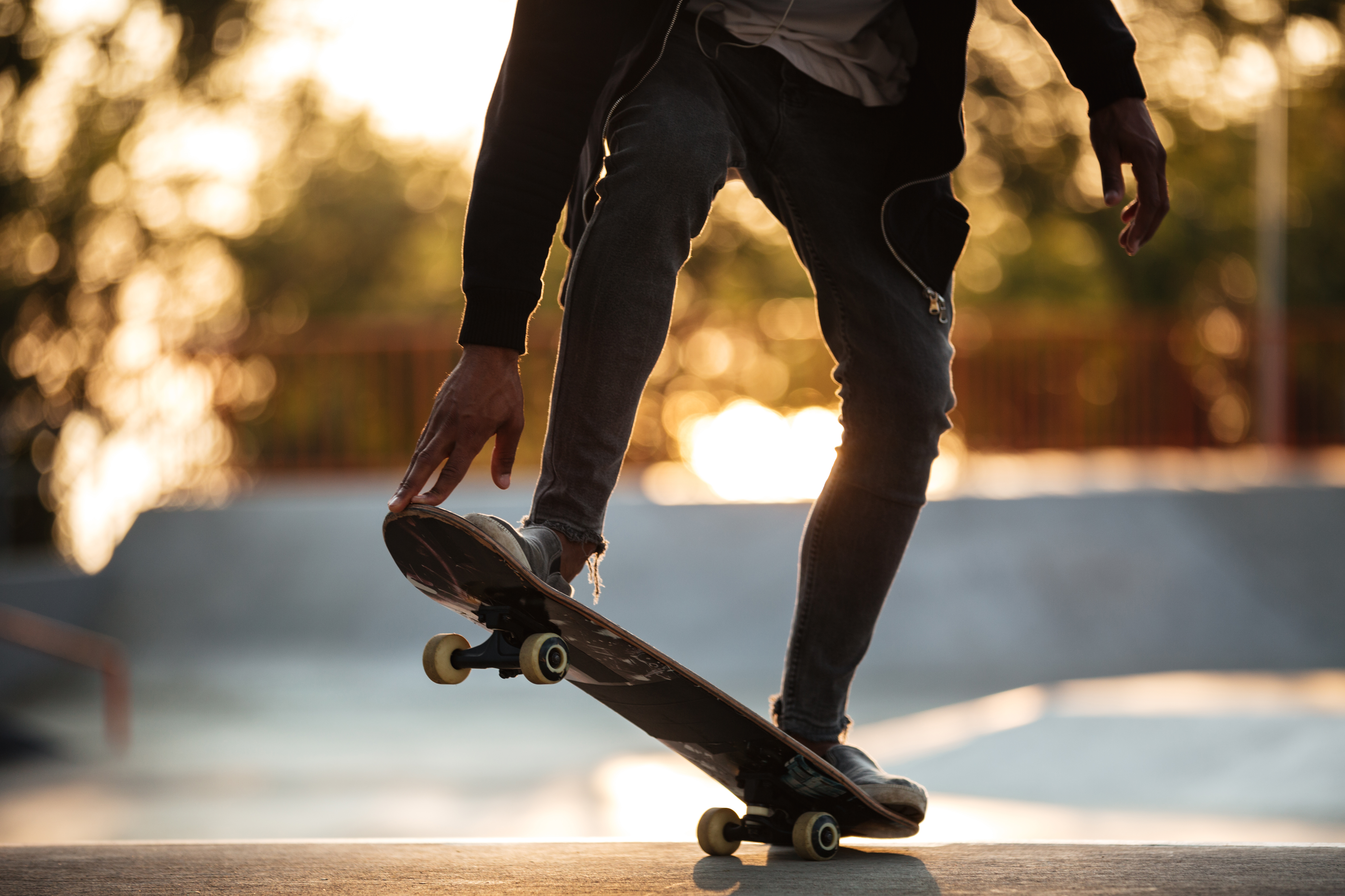 A young african male teenager on a skateboard