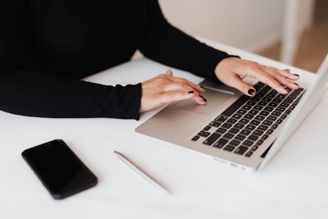 A woman working on a netbook in an office