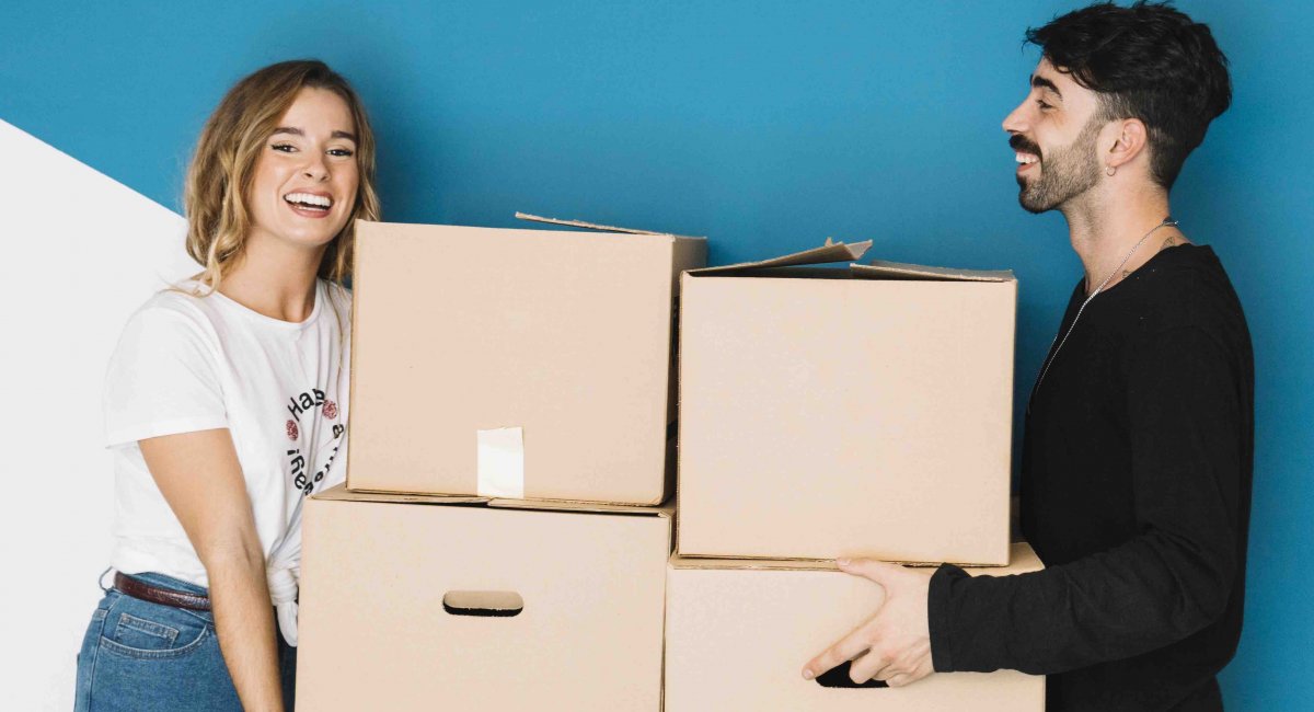 A young couple moving to new flat