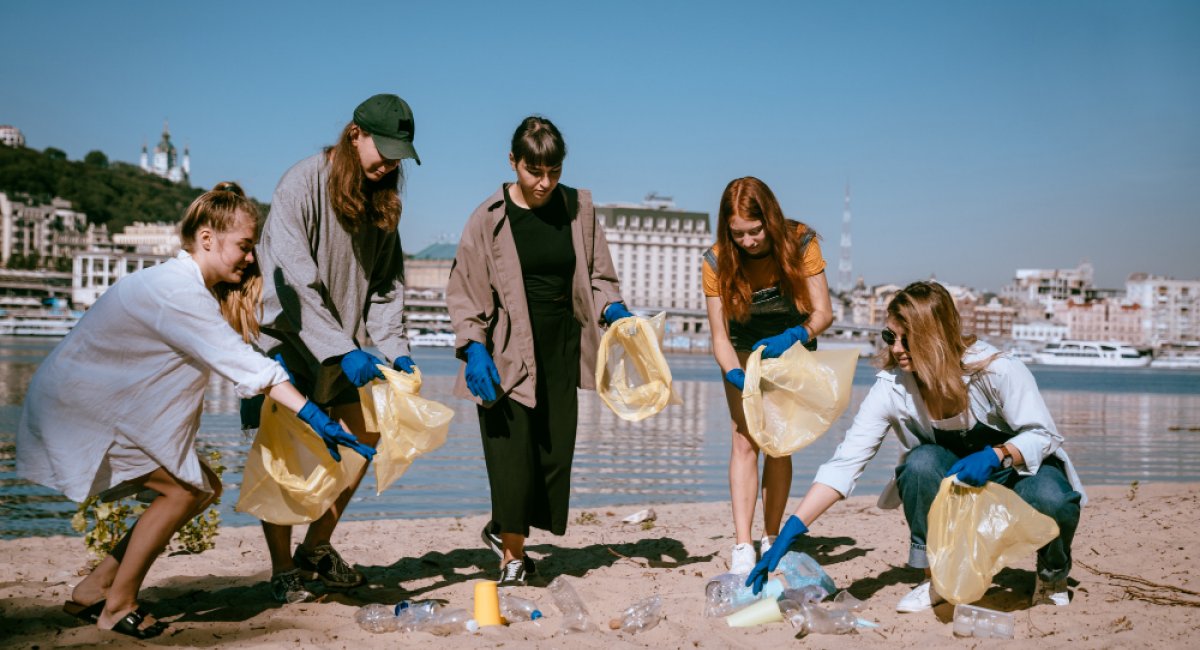 A group people collecting plastic waste on the beach