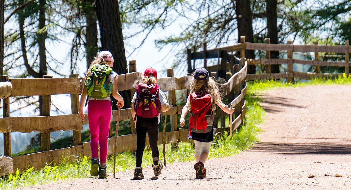 girls hiking forest path