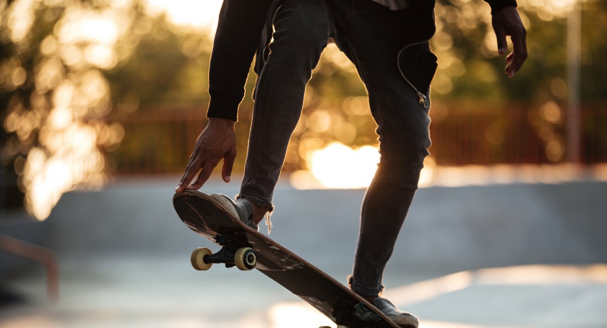 A young african male teenager on a skateboard