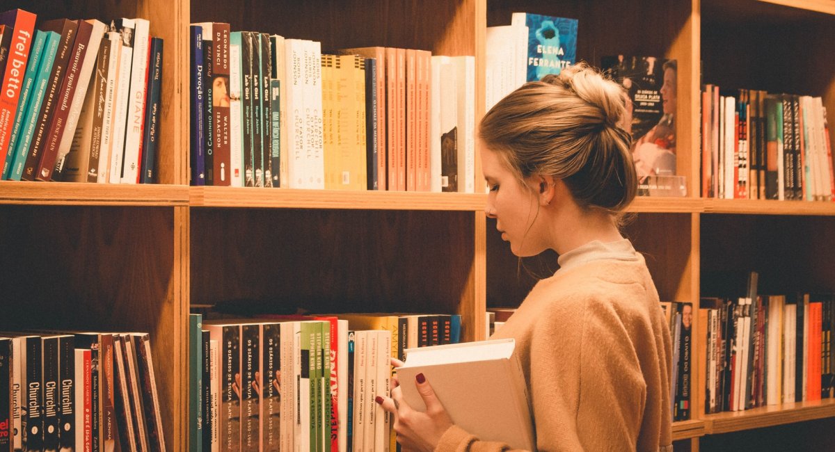 Girl at a library choosing a book