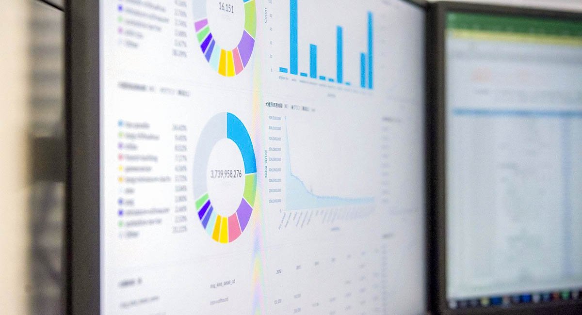 computer monitors with charts and graphs